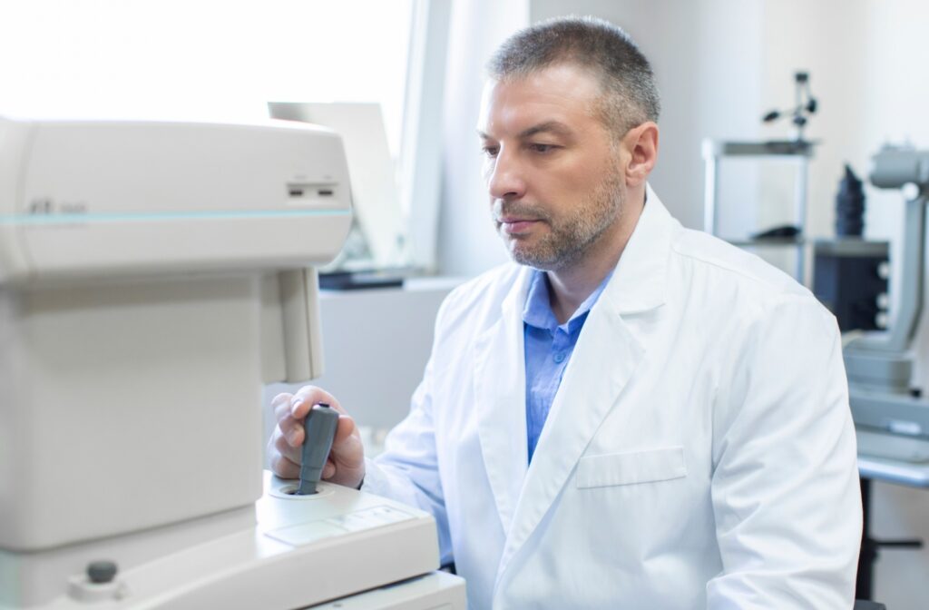 Eye care professional operating diagnostic equipment during a vision exam