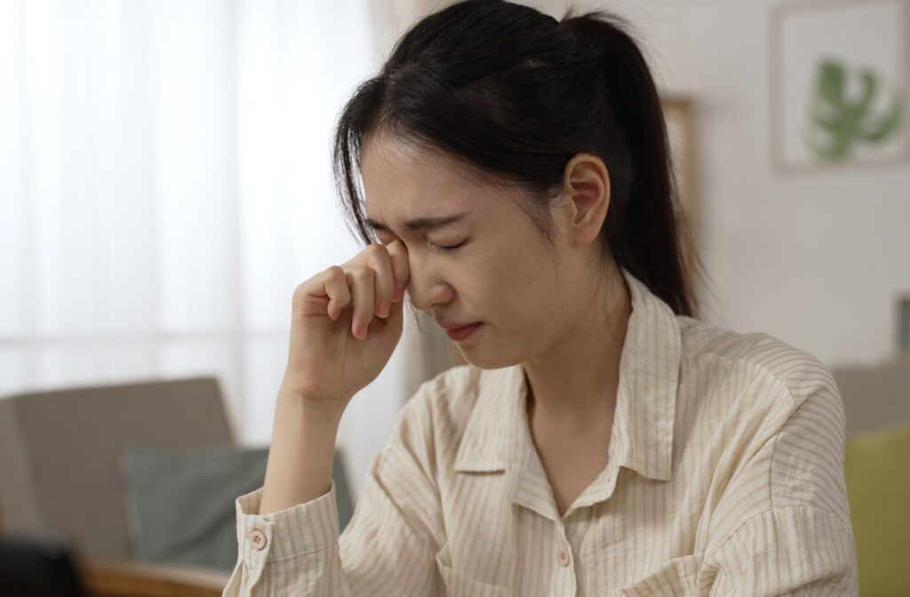 Person rubbing their eye due to discomfort or irritation.