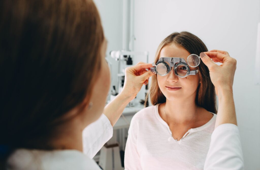 Young person undergoing a comprehensive eye exam with optometrist equipment.