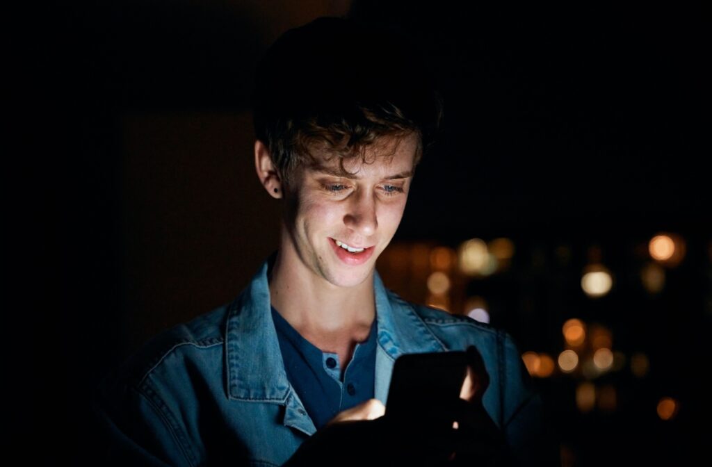 A person using their phone in the dark